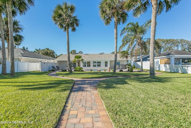 ranch-style home featuring a front lawn