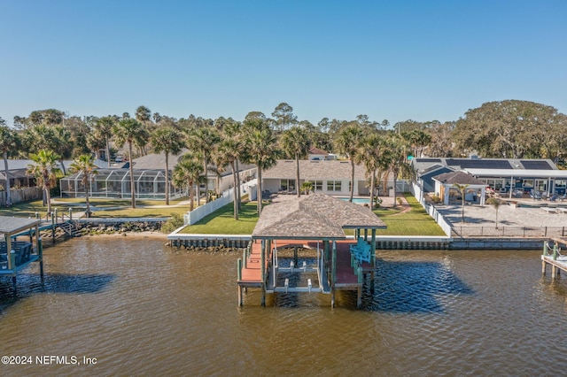 dock area with a lawn and a water view