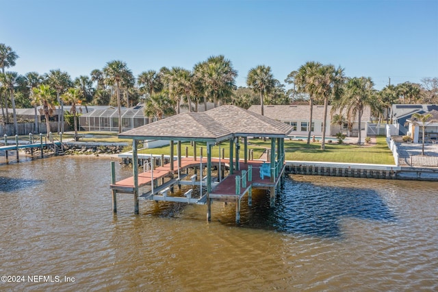 dock area with a yard and a water view