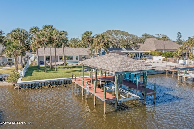 dock area featuring a water view and a lawn