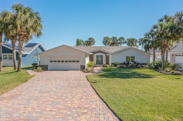 ranch-style home with a garage and a front lawn