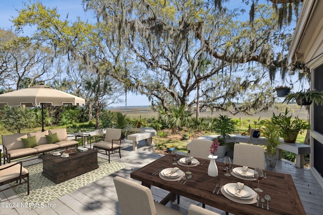 wooden terrace with an outdoor living space