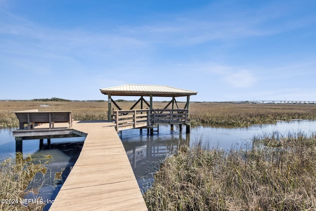 dock area with a gazebo and a water view