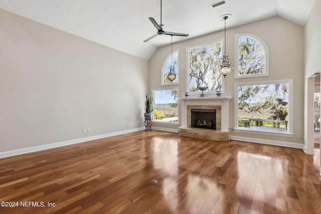 unfurnished living room with ceiling fan, wood-type flooring, and vaulted ceiling