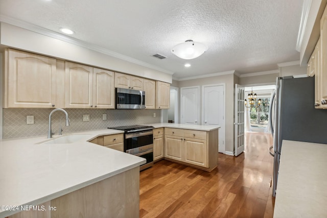 kitchen with kitchen peninsula, appliances with stainless steel finishes, dark wood-type flooring, sink, and light brown cabinets