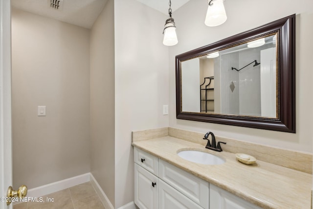 bathroom featuring a shower, vanity, and tile patterned floors