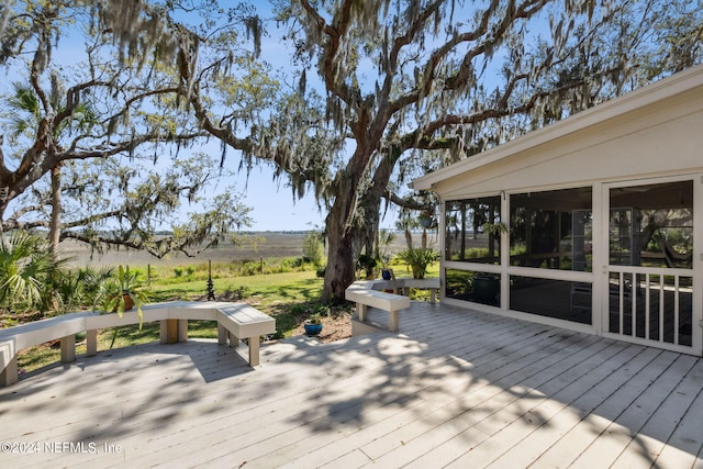 wooden deck with a sunroom