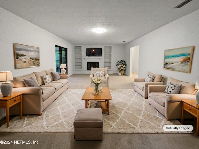 living room featuring carpet, built in shelves, a textured ceiling, and a brick fireplace