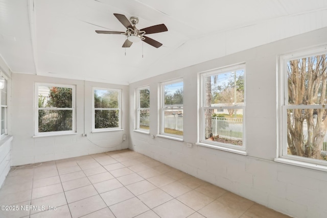 unfurnished sunroom featuring ceiling fan and vaulted ceiling