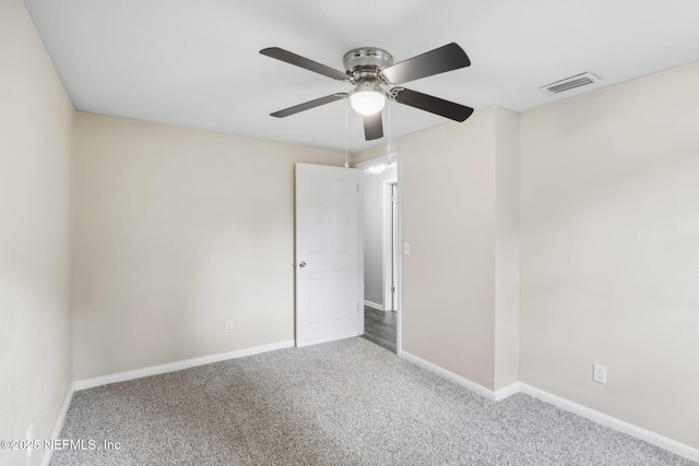 carpeted spare room featuring ceiling fan