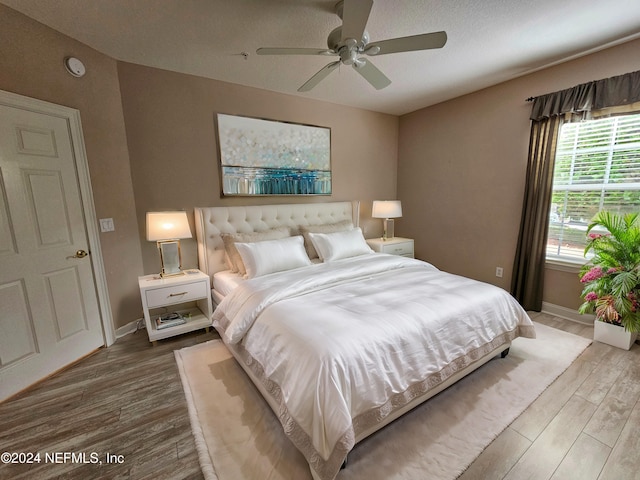 bedroom with hardwood / wood-style flooring and ceiling fan