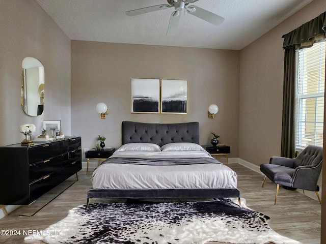 bedroom with ceiling fan and light hardwood / wood-style floors