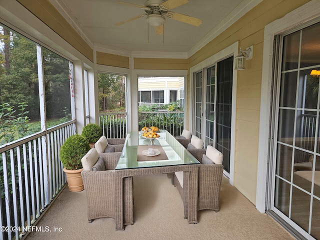 sunroom / solarium with a wealth of natural light and ceiling fan