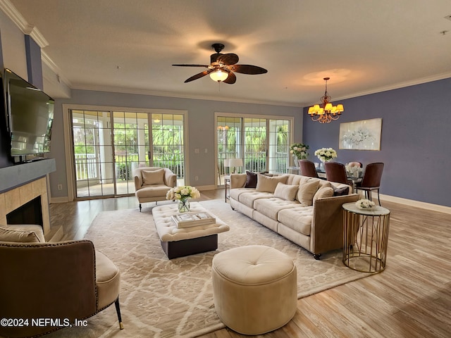 living room with crown molding, a wealth of natural light, and light wood-type flooring