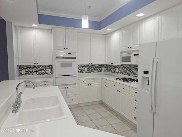 kitchen featuring sink, white cabinetry, crown molding, decorative light fixtures, and white appliances