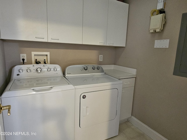 clothes washing area with cabinets, independent washer and dryer, and electric panel