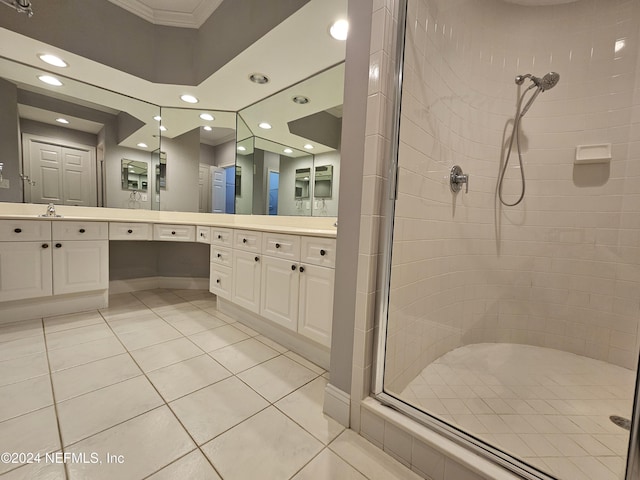 bathroom with tile patterned flooring, vanity, and tiled shower