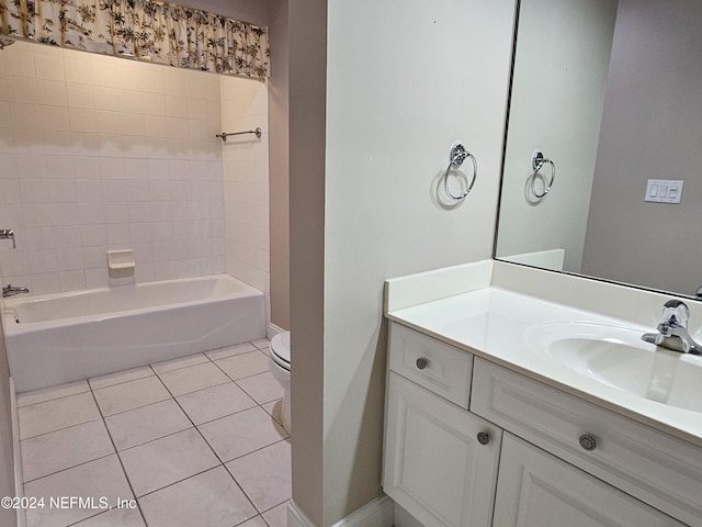 full bathroom featuring tile patterned floors, toilet, tiled shower / bath combo, and vanity