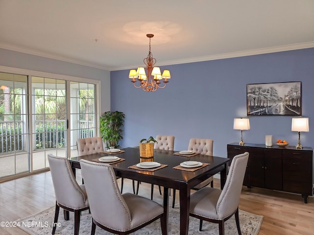 dining room featuring crown molding, a notable chandelier, and light hardwood / wood-style floors