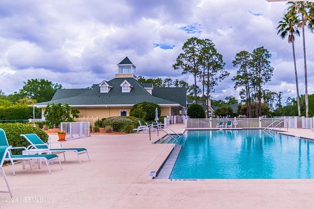 view of swimming pool featuring a patio area