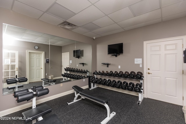 gym with a paneled ceiling