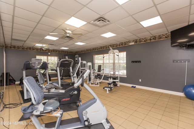 workout area featuring a paneled ceiling and ceiling fan