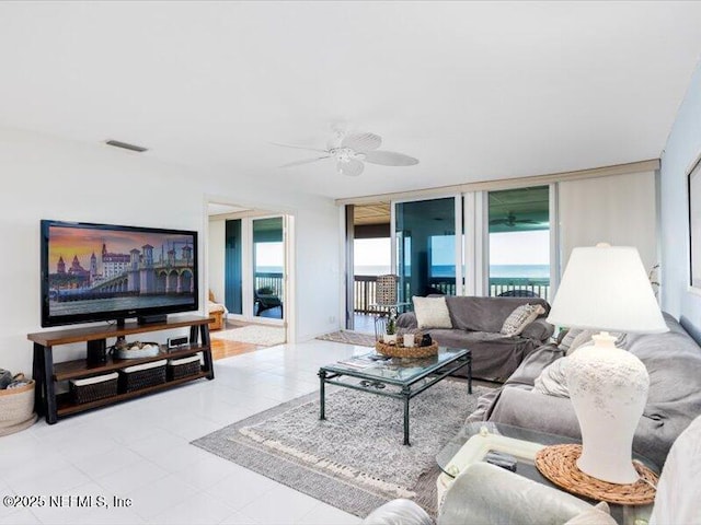 living room with ceiling fan and light tile patterned flooring