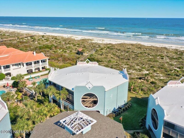 aerial view with a water view and a beach view