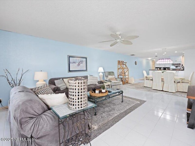 tiled living room featuring a textured ceiling and ceiling fan