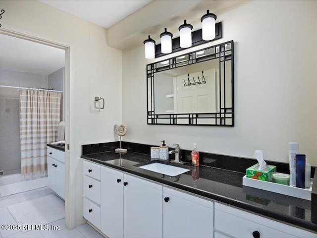 bathroom with tile patterned flooring and vanity