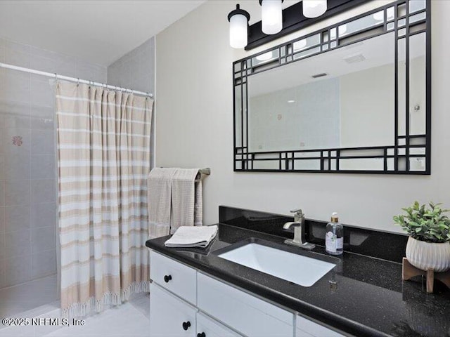 bathroom with a shower with curtain and vanity