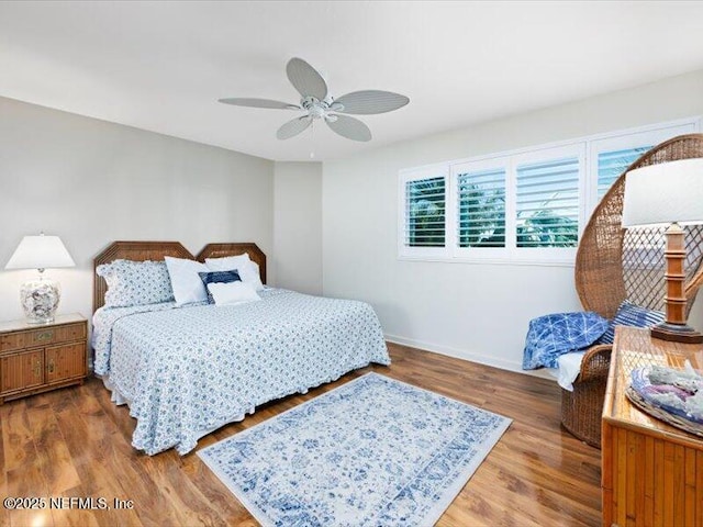 bedroom with hardwood / wood-style flooring and ceiling fan