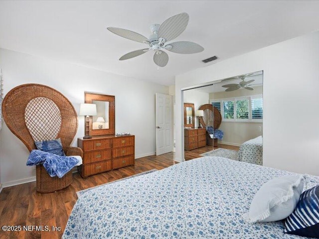 bedroom with a closet, dark hardwood / wood-style floors, and ceiling fan