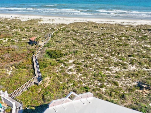 birds eye view of property featuring a water view and a view of the beach