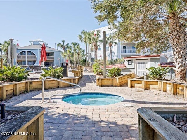 view of swimming pool featuring a community hot tub and a patio