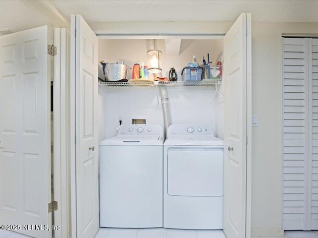 laundry area featuring separate washer and dryer and light tile patterned flooring