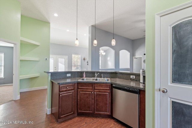 kitchen with pendant lighting, a wealth of natural light, sink, and stainless steel dishwasher