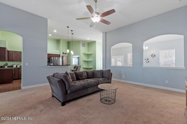 living room with ceiling fan, built in features, and light carpet