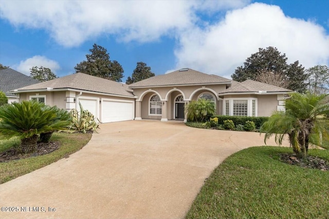 mediterranean / spanish-style home with a garage