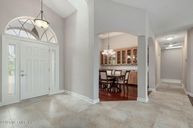 foyer entrance with a chandelier