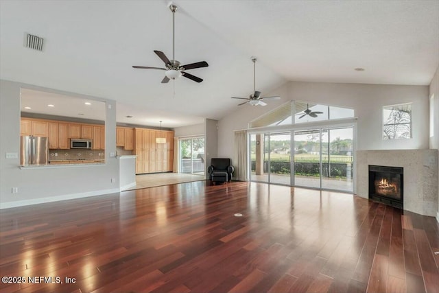 unfurnished living room with dark hardwood / wood-style flooring and high vaulted ceiling