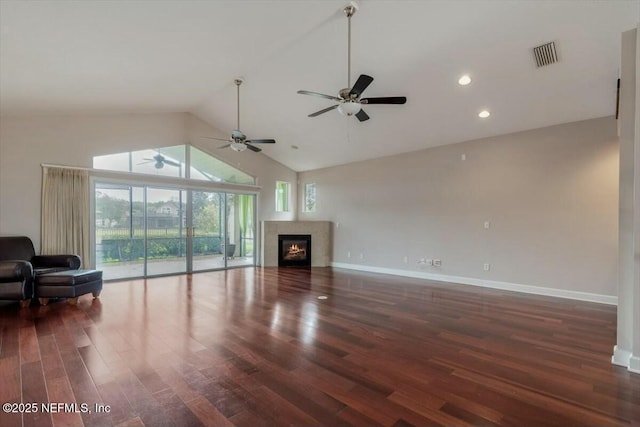 living room featuring ceiling fan, dark hardwood / wood-style flooring, and lofted ceiling