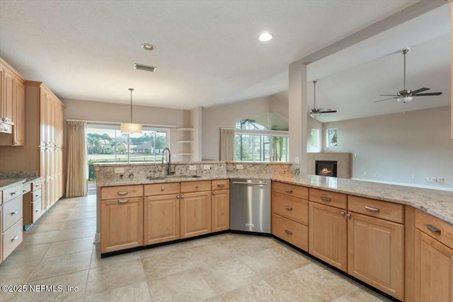 kitchen with lofted ceiling, sink, stainless steel dishwasher, ceiling fan, and light stone countertops