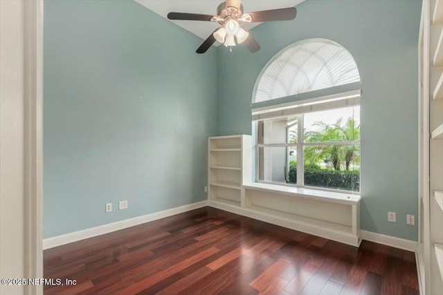 unfurnished room with ceiling fan, dark wood-type flooring, and a wealth of natural light