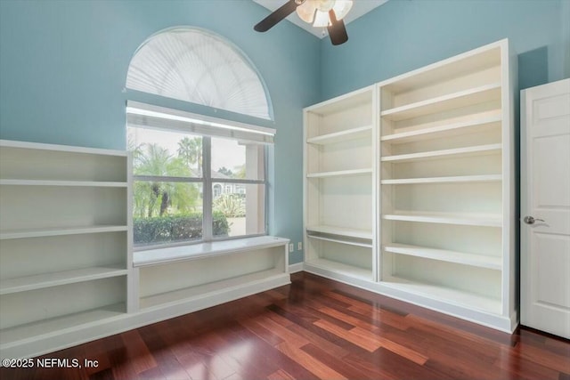 empty room featuring ceiling fan and dark wood-type flooring