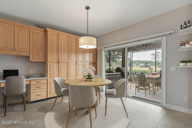 tiled dining area featuring built in desk