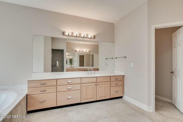 bathroom featuring tile patterned flooring and vanity