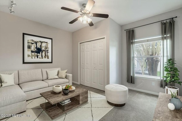 carpeted living room featuring plenty of natural light and ceiling fan