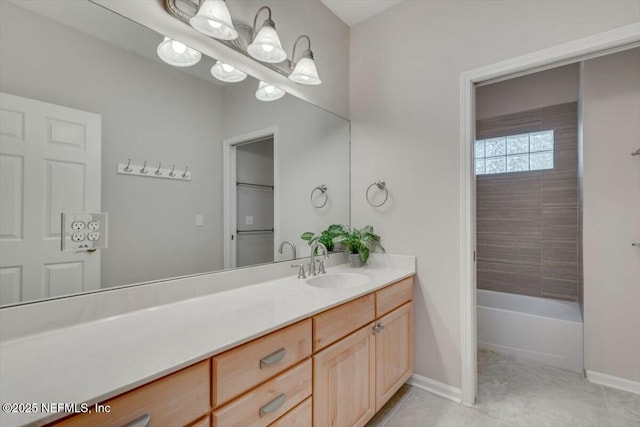 bathroom featuring vanity, tiled shower / bath combo, and an inviting chandelier