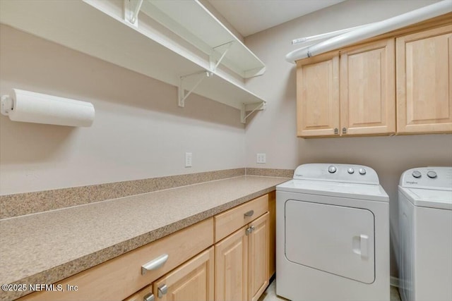 laundry area with cabinets and independent washer and dryer